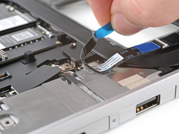 Use your fingers to peel the fingerprint sensor cable away from the frame and separate the adhesive.
