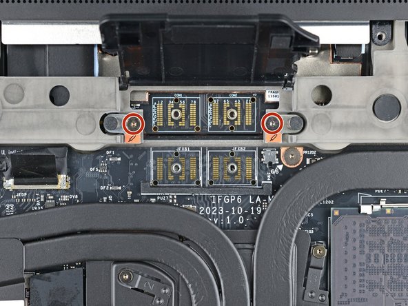 Use your Framework Screwdriver to loosen the two captive T5 Torx screws securing the module in the Expansion Bay.