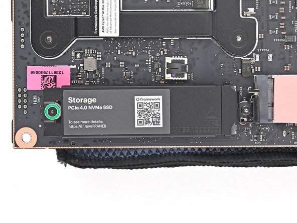 Use your Framework Desktop Screwdriver to loosen the captive T5 Torx screw securing the secondary storage.