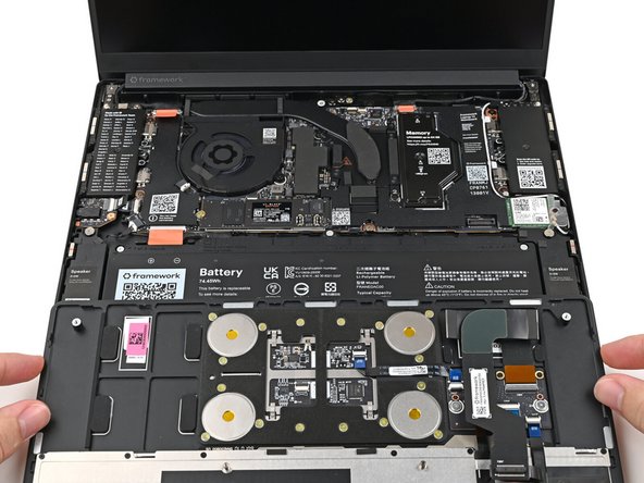 Position the Input Cover, keyboard down, on top of the laptop so it just covers the Battery.
