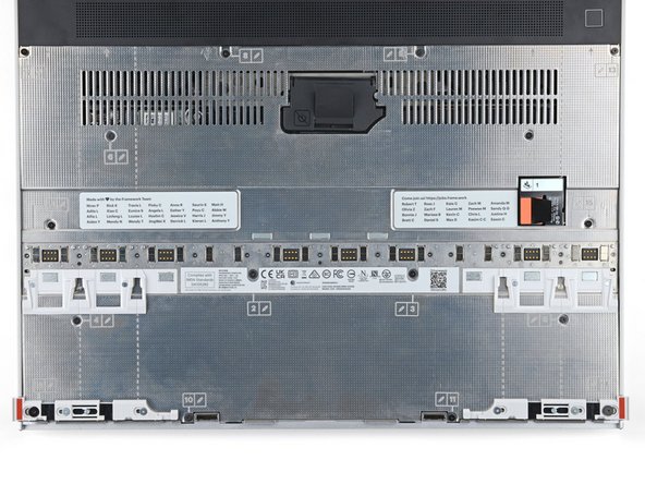 Use your Framework Screwdriver to loosen the 16 captive T5 Torx screws securing the Mid Plate.