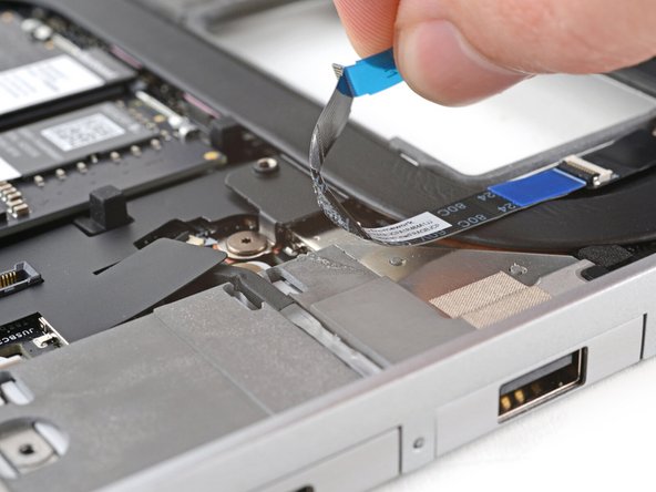 Use your fingers to peel the fingerprint sensor cable away from the frame and separate the adhesive.