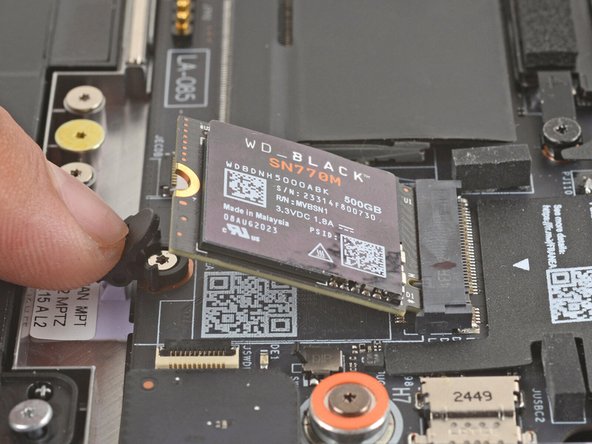 The SSD will pop up to an angle when it's unlatched.
