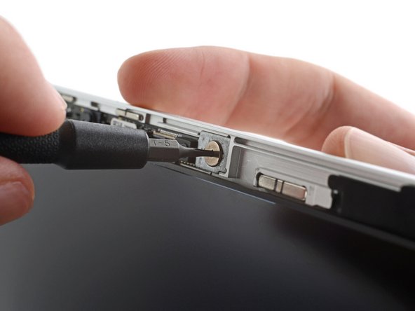 While supporting the screen with one hand, use your Framework Screwdriver to install the two 2.0 mm‑long T5 Torx screws securing the webcam.