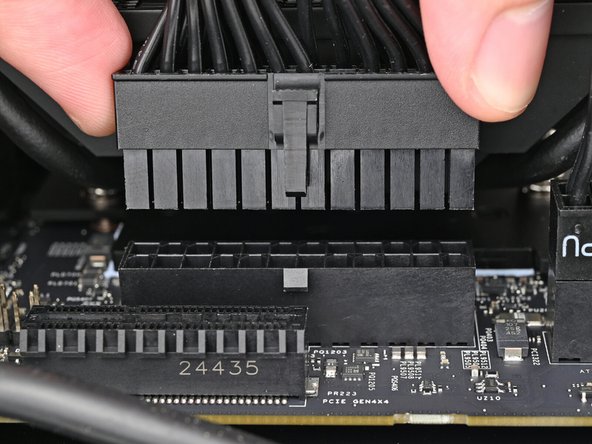 Orient the 24-pin main power supply cable so its clip is facing away from the heatsink.