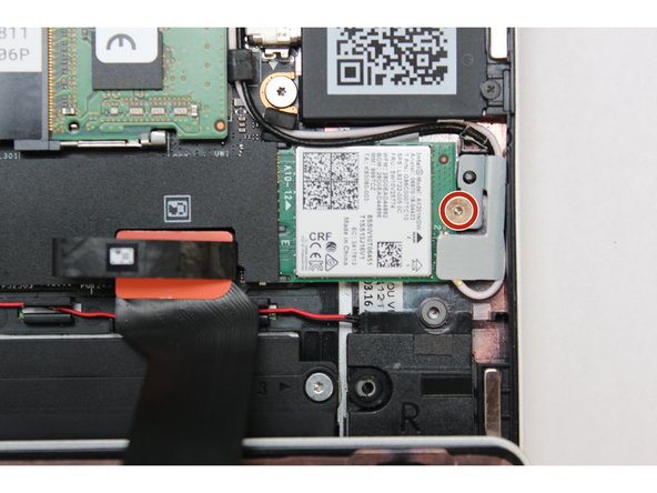 Place the WiFi Bracket over the WiFi module and place the fastener in the hole. Using the T5 bit in the Framework Screwdriver, screw the fastener into place.