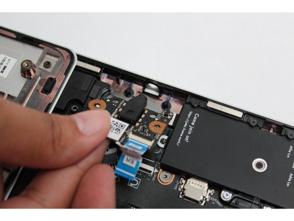 Place the Audio Board down by aligning the holes on the Audio Board with the alignment pins on the Bottom Cover and insert the headphone connector through the hole on the left hand side of the Bottom Cover.