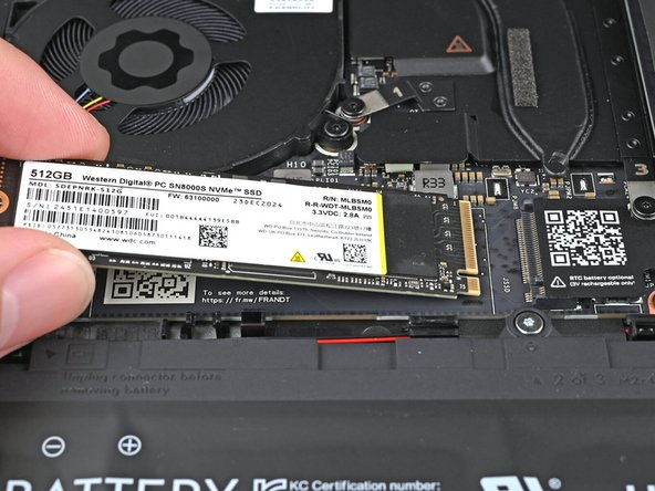 Hold the SSD by its edges. Don't touch the gold contacts with your fingers. If you do, wipe the contacts with a clean, lint-free cloth to remove any finger oils.