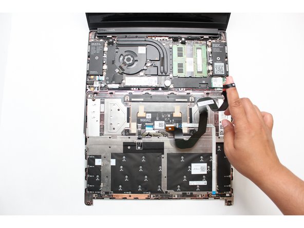Locate the loop on the end of the Touchpad Cable and insert your finger into it.