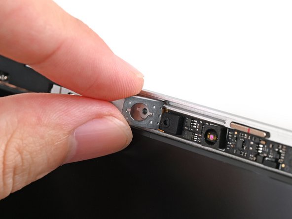 Use your fingers to place the washers into their spots on the Top Cover.