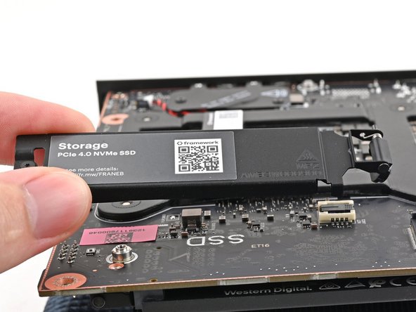 Lift the secondary storage heat spreader out of the Desktop and remove it.