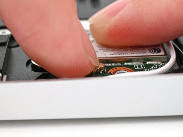 Hold the Wi-Fi module down with your finger.