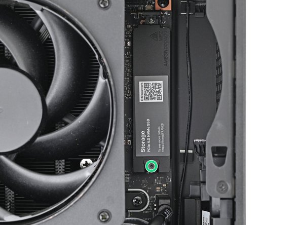 Use your Framework Desktop Screwdriver to loosen the captive T5 Torx screw securing the SSD.