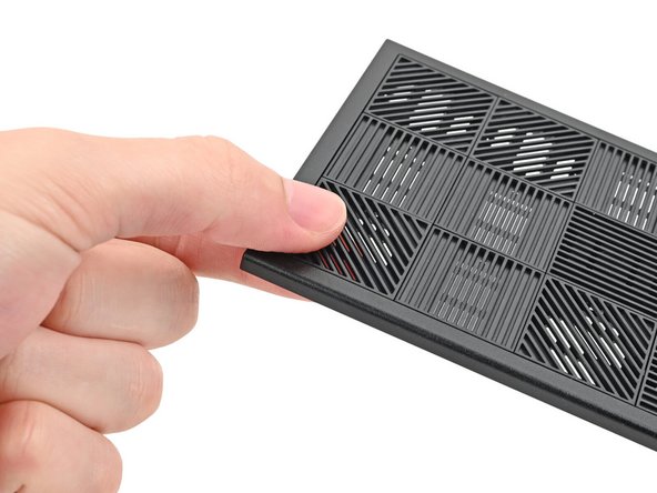 Use your fingers to push the bottom of the Tile up and off the front panel and release its clips.