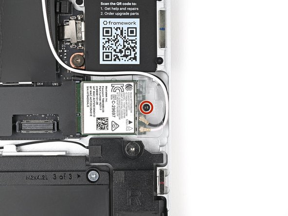 Use your Framework Screwdriver to tighten the captive T5 Torx screw securing Wi-Fi module.