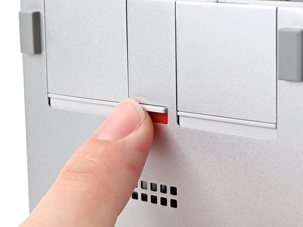 Use your finger to flip the Expansion Card latch into the unlocked position.