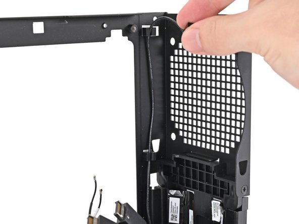 Push the power button cable into its rubber clips on the chassis.