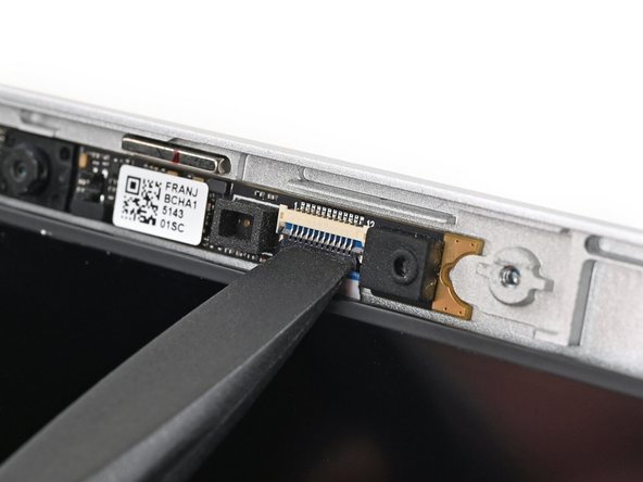 Use the flat end of your Framework Screwdriver, or a clean fingernail, to press down the locking tab on the webcam ZIF connector.