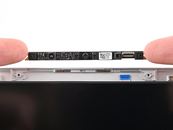 If your replacement webcam comes with liners covering the lenses, remove them now.