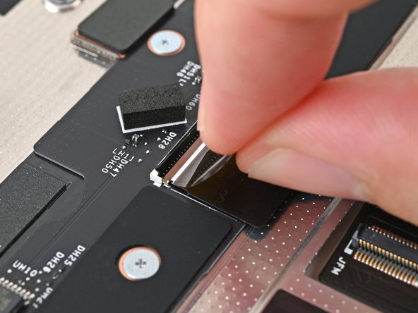 Use your fingers to grip the black pull tab and slide the Mid Plate Cable straight into its socket.