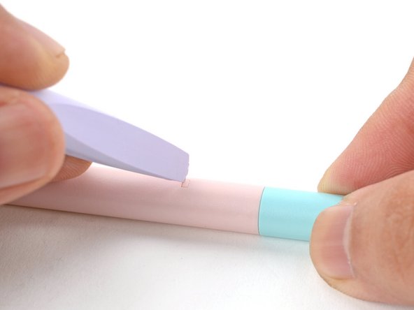 Use the corner of your Framework Screwdriver or a small pin to depress the small rectangular battery clip on the barrel of the Stylus, near the cap.