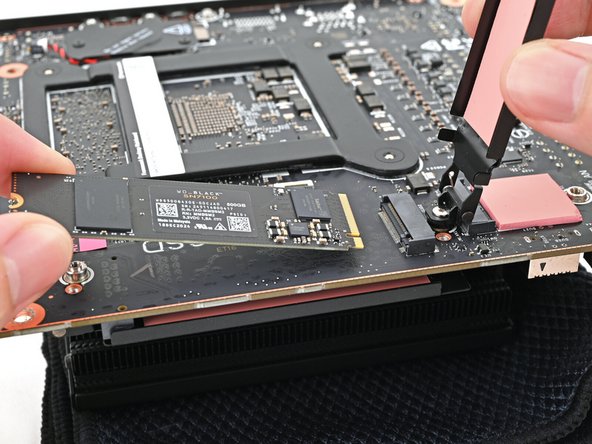 Hold the SSD by its edges. Don't touch the gold contacts with your fingers. If you do, wipe the contacts with a clean, lint-free cloth to remove any finger oils.