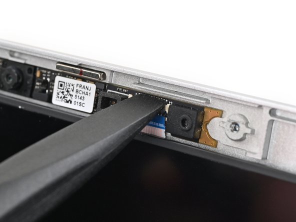 Use the flat end of your Framework Screwdriver, or a clean fingernail, to press down the locking tab on the webcam ZIF connector.