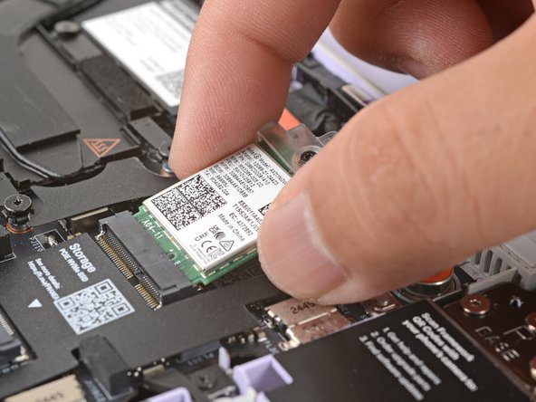 Align the Wi-Fi card's gold contacts and notch with the socket on the Mainboard.