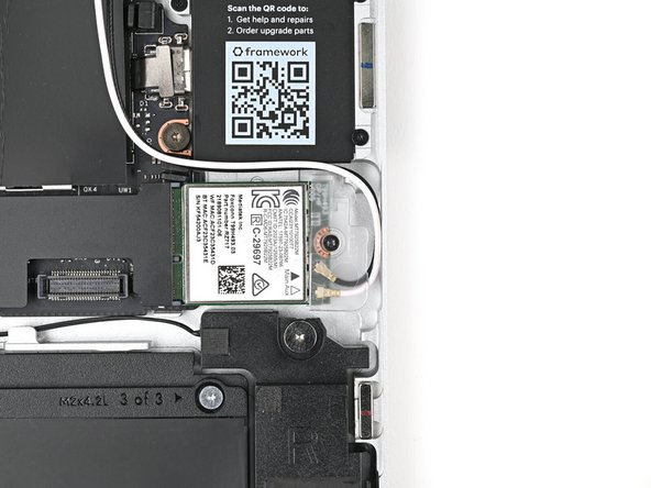 Use your Framework Screwdriver to tighten the captive T5 Torx screw securing Wi-Fi module.