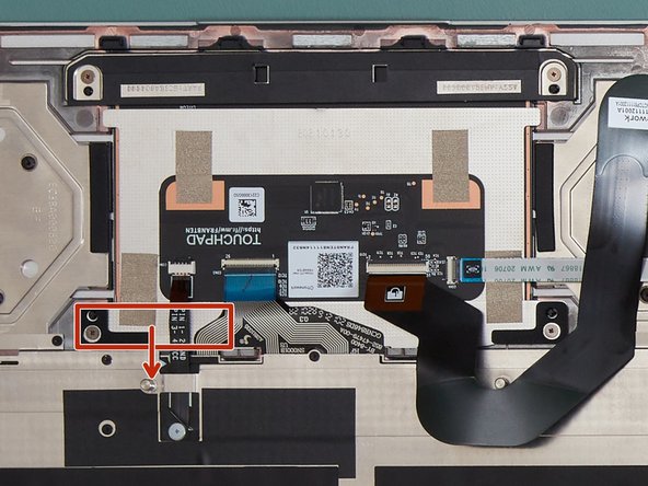 Slide the Touchpad downward (in the direction of the keyboard), holding it by the bracket boxed in red in the image.