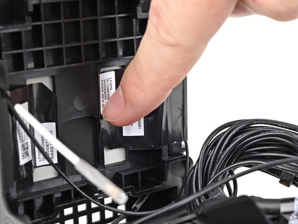 Press the left antenna's copper film onto the chassis and adhere it.