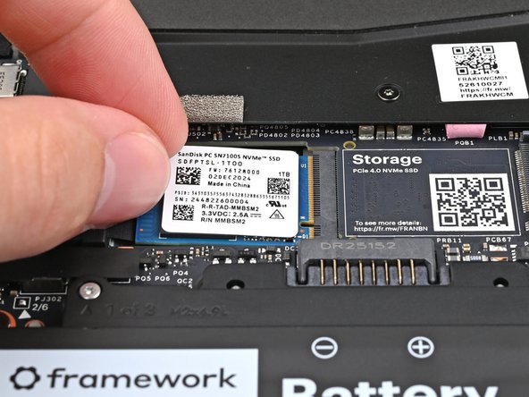 Insert the SSD partially into the socket at a shallow angle. You should still be able to see most of the gold contacts.