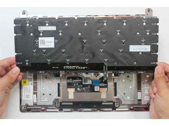 Once all screws are removed use the spudger end of the Framework Screwdriver or your fingernail to lift any corner of the keyboard off the Input Cover. The keyboard is now fully removed from the Input Cover.
