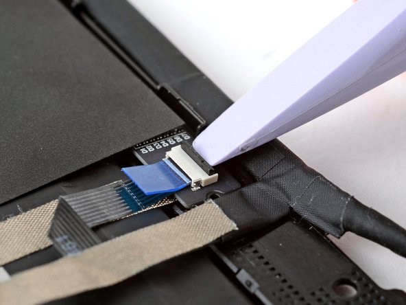 Use your fingers to grab the touch control cable by the blue tab and slide the cable out of the connector.