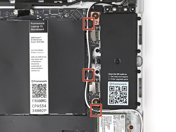 Use the flat end of your Framework Screwdriver to press the two Antenna Cables into their rubber clips on the Mainboard.