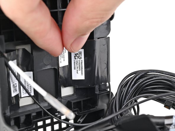 Press the left antenna's copper film onto the chassis and adhere it.