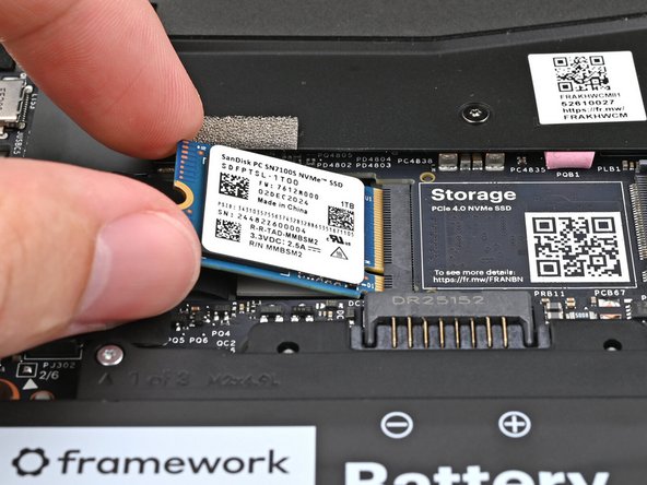 Align the SSD's gold contacts with its socket.