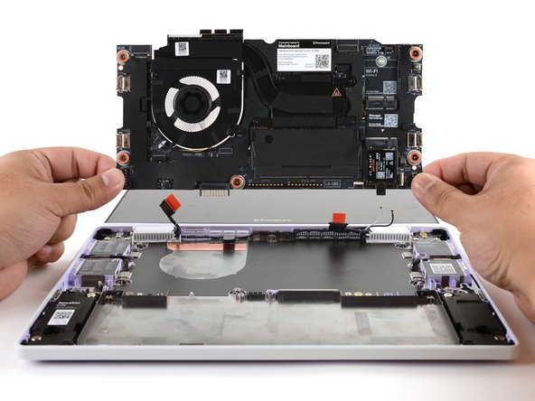 Use your fingers to grab the Mainboard by its edges.