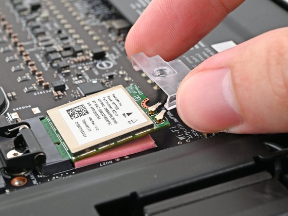 Hook the Wi-Fi bracket over the corner of the Wi-Fi module opposite the antenna cables.