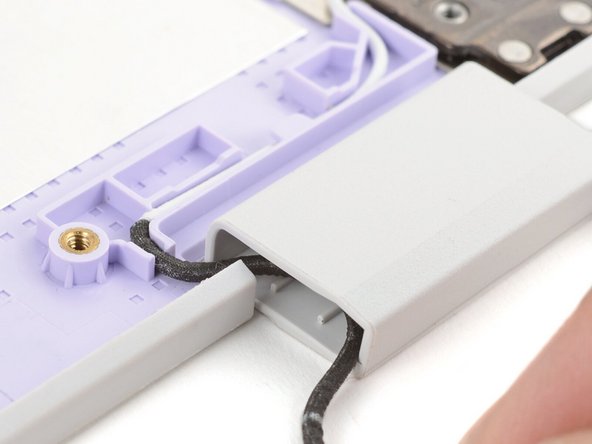 Make sure both antenna cables are properly routed in the Top Cover and tucked into the hinges, as shown in the images.