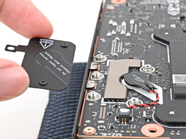 Place the cover over the RTC battery and align its screws.