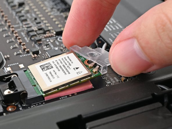 Rotate the bracket over the Wi-Fi module, making sure the screw hole isn't being obstructed by the antenna cables.