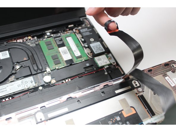 Once the Touchpad Cable is disconnected, remove the Input Cover away from the Mainboard.