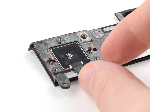 Lift the fingerprint reader out of its slot in the ventilation plate and remove it.