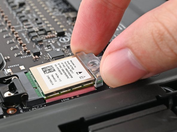 Rotate the bracket over the Wi-Fi module, making sure the screw hole isn't being obstructed by the antenna cables.