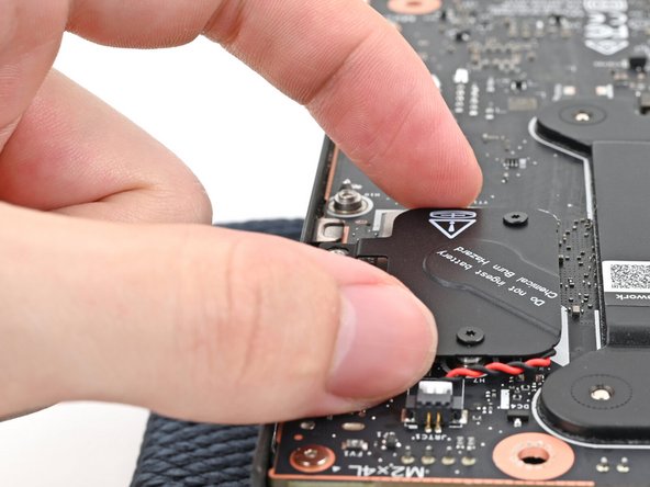 Place the cover over the RTC battery and align its screws.