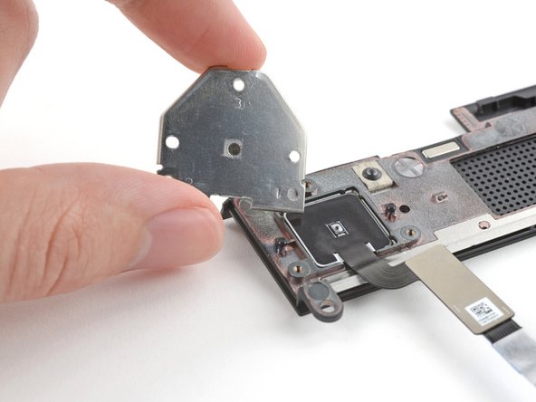 Use the flat end of your Framework Screwdriver to lift the fingerprint reader cover and remove it.