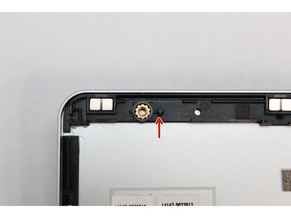 There are four alignment pins located on the Top Cover.  They are located right next to the four fastener slots.  Place the silver brackets connected to Display directly over the pins.