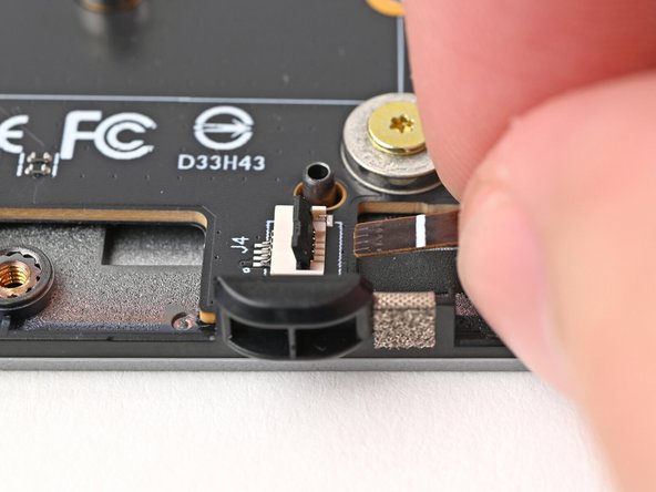 Use your fingers to grip the brown pull tab and slide the right fan cable straight into its socket.