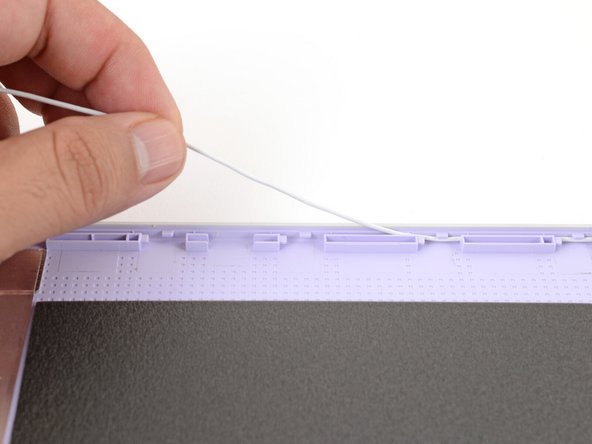 Carefully guide the white antenna cable out of its channel.